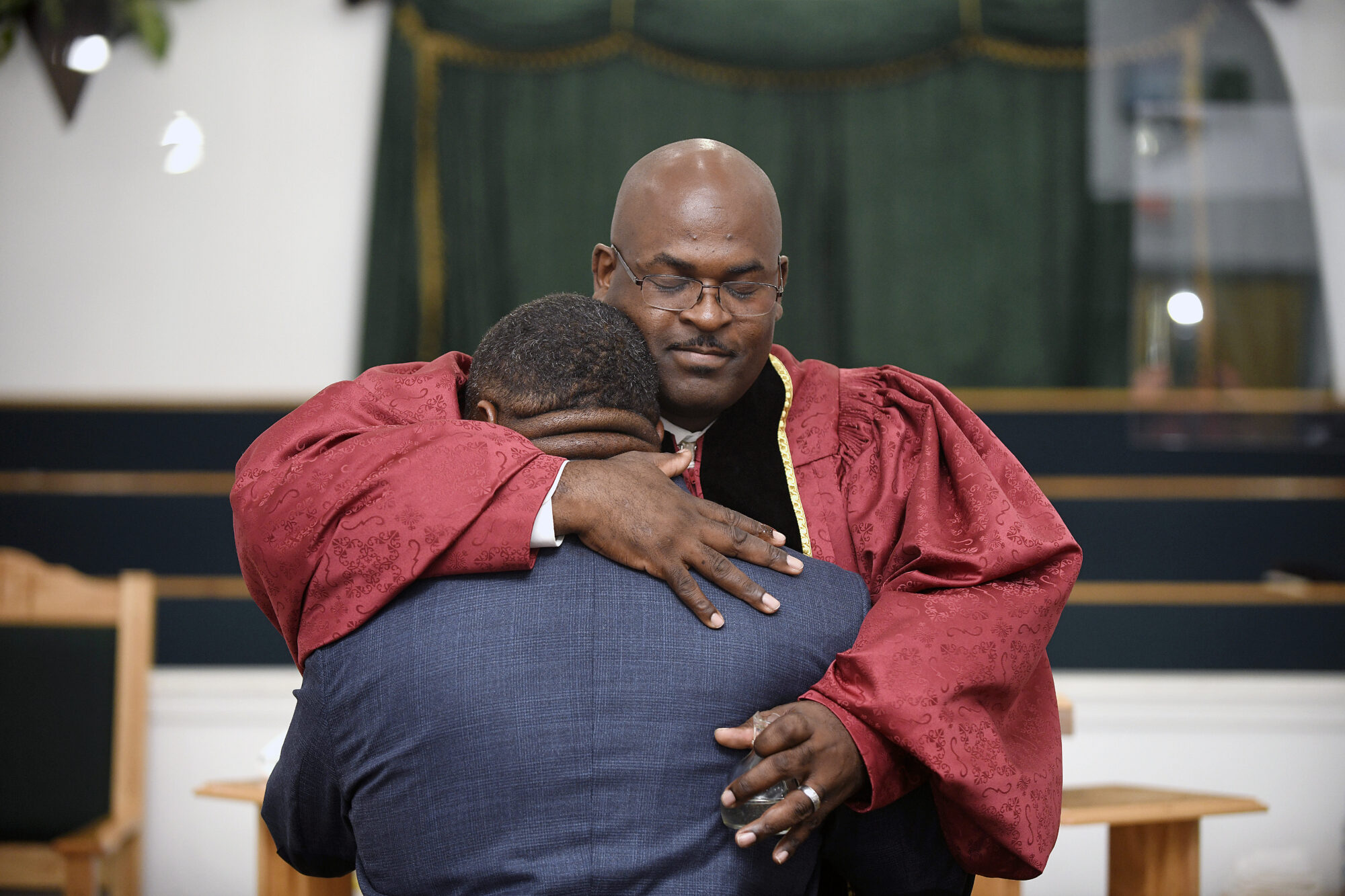 The Reverend Kenneth B. Thomas Sr., pastor of Bethesda Worship and Healing Center in Jonesboro, Arkansas, hugs Cory Brigham after ordaining him into the ministry during Sunday service on August 15, 2021. All photos by Terrance Armstard for The Guardian.