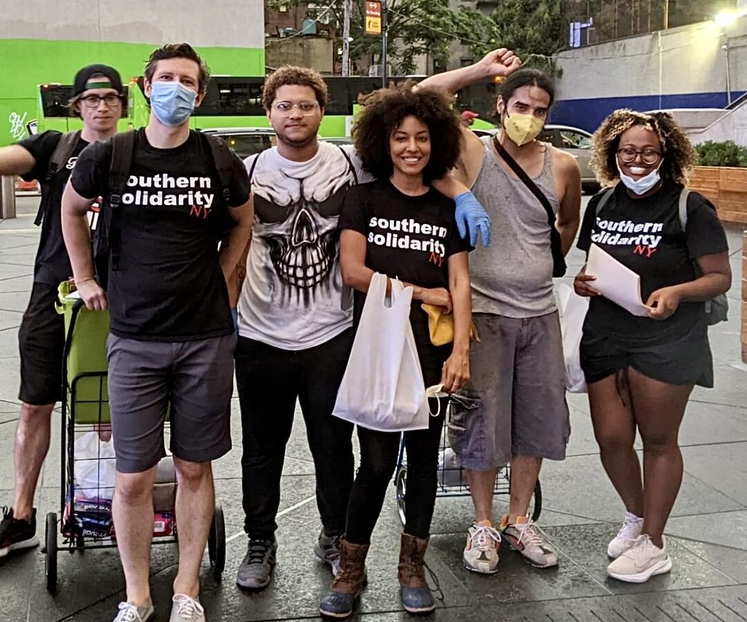 Volunteers with Southern Solidarity's New York team pause for a photo while handing out supplies to the city's unhoused folks.