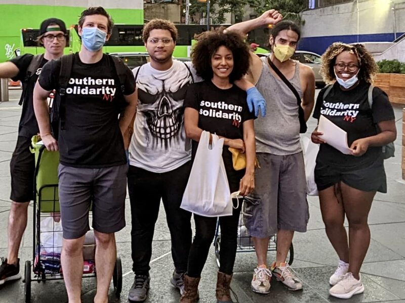 Volunteers with Southern Solidarity's New York team pause for a photo while handing out supplies to the city's unhoused folks.