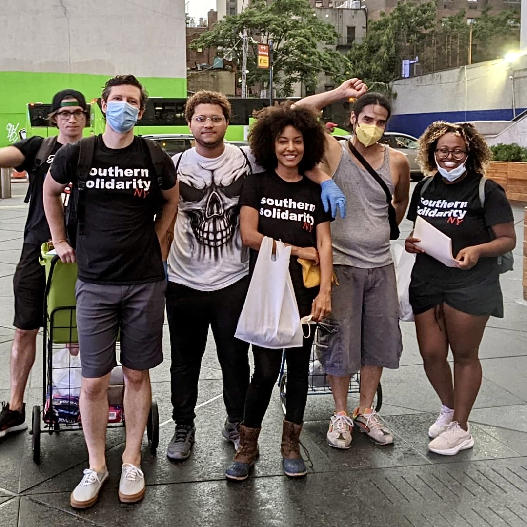Volunteers with Southern Solidarity's New York team pause for a photo while handing out supplies to the city's unhoused folks.
