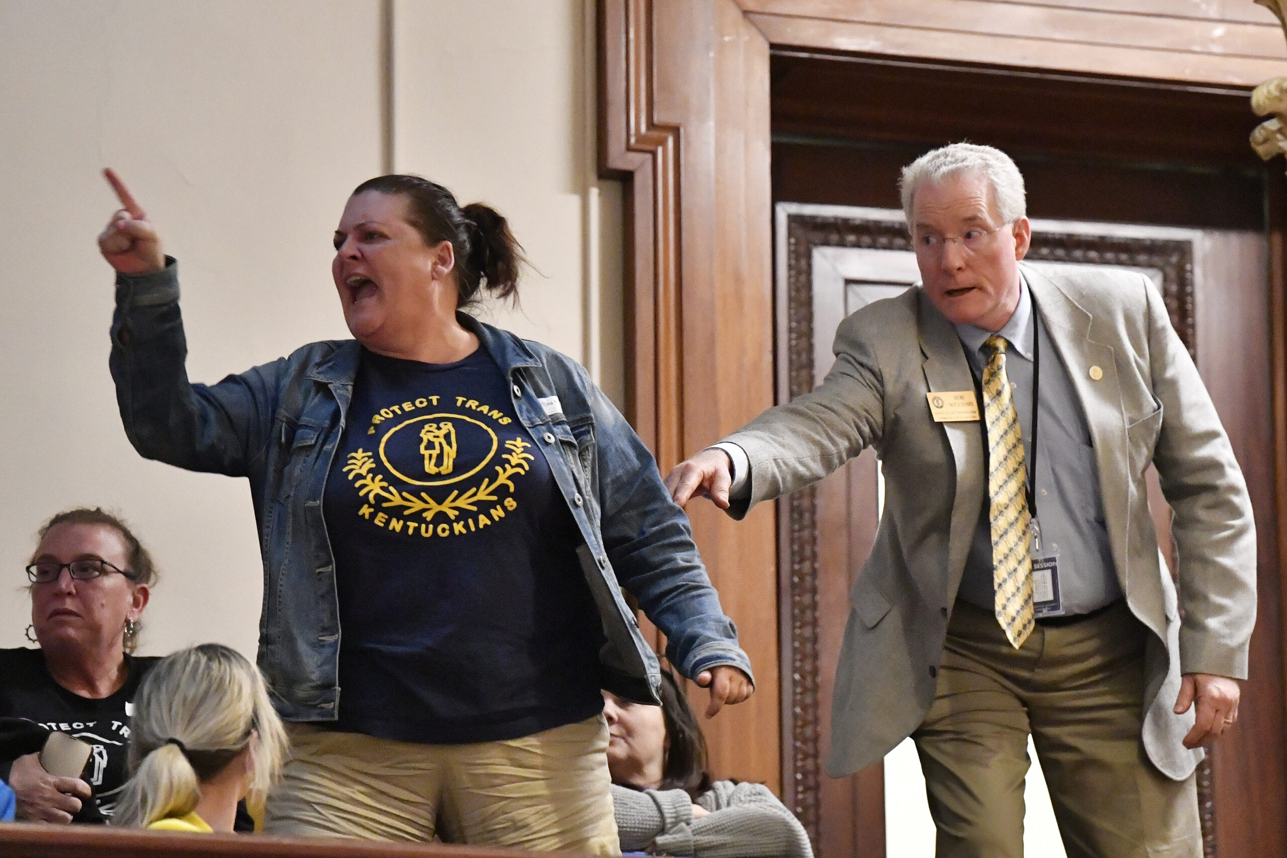 A visitor in the Kentucky Senate Gallery is escorted out by a doorkeeper as she shouts in anger at the passage of Senate Bill 150 at the Kentucky Senate in Frankfort, Kentucky, on Thursday, March 16, 2023. (AP Photo/Timothy D. Easley)
Finding hope and solidarity for LGBTQ Kentucky youth. A trans student on how they and other LGBTQ Kentucky youth are dealing with the mental health fallout of Senate Bill 150 in schools.
