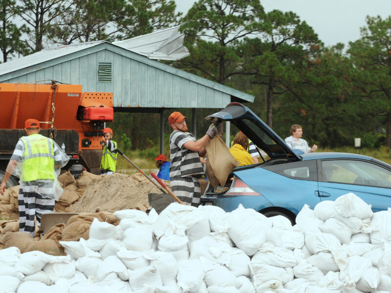 Men from the Brevard County Jail fill sand bags for local residents to combat flooding caused by high water levels from Hurricane Irma on October 5, 2017 in Sharpes, Florida. Credit: Paul Hennessy/Alamy Live News.
