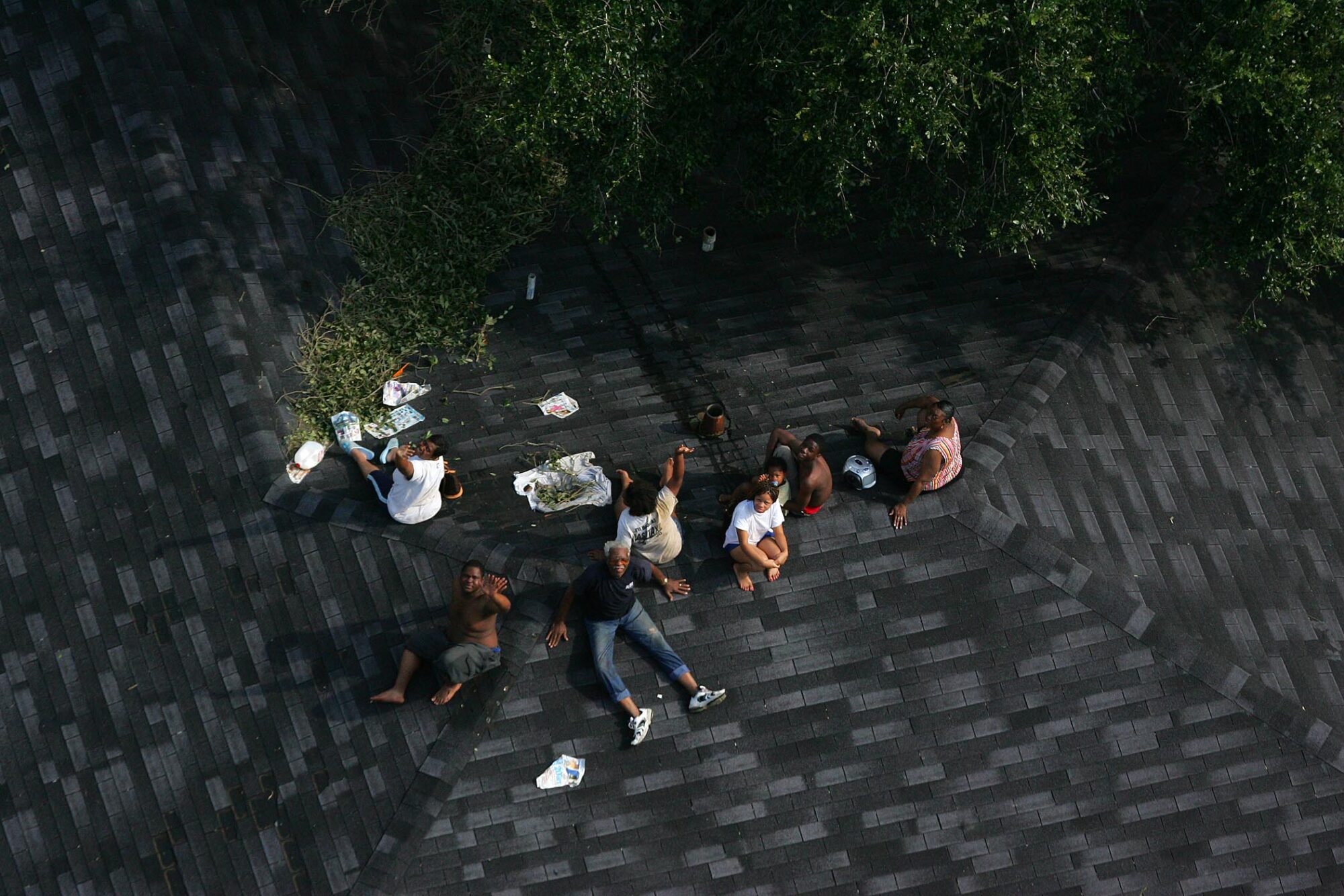 Residents seek higher ground on the roof of a home as floodwaters from Hurricane Katrina cover the streets on Tuesday, August 30, 2005 in New Orleans. (AP Photo/ Vincent Laforet, Pool) What we can learn from Hurricane Katrina preparedness failures and the deep inequities in federal disaster response efforts they exposed.