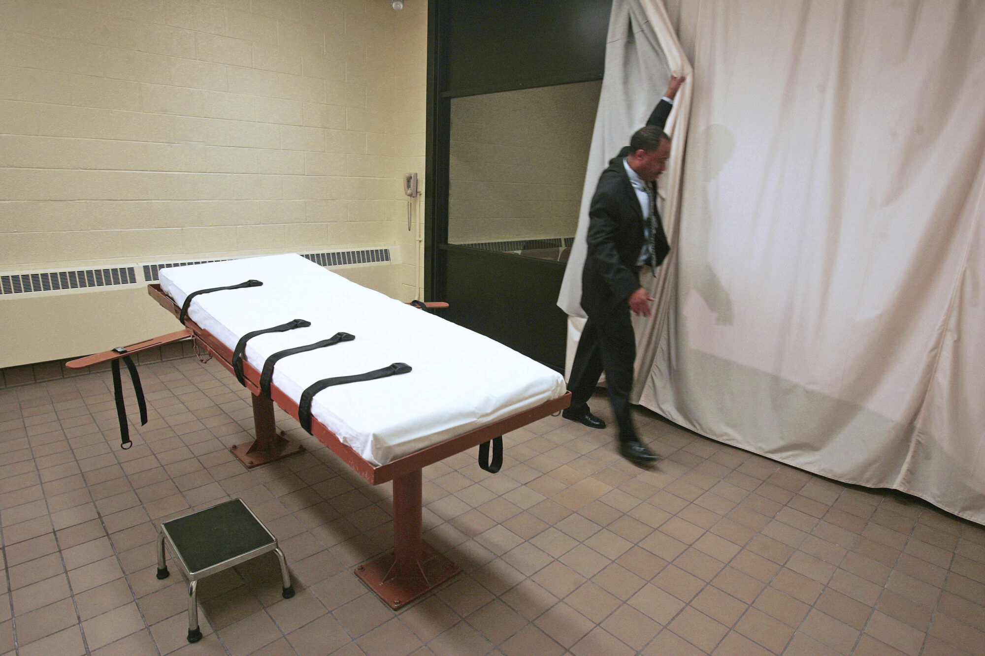 In this November 2005 file photo, Larry Greene, public information director of the Southern Ohio Correctional Facility, demonstrates how a curtain is pulled between the death chamber and witness room at the prison in Lucasville, Ohio. (AP Photo/Kiichiro Sato, File) Author Keith LaMar's execution date was moved to 2027 after 30 years on Death Row in Ohio, awaiting the death penalty.