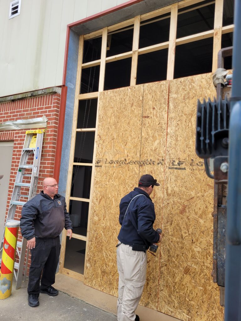 In the wake of Ida, firefighter Casey Chaisson and Lt. Joshua Landry assist crews in constructing a wall to address a damaged area of the department's Little Caillou Admin 2 Station.